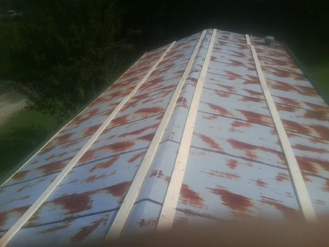 Rusted metal roof panels with new wood purlins before replacement — Storm Damage Roof Repair in Dade City by Roofing Brothers